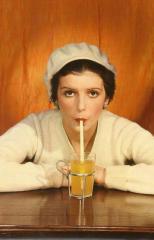 Woman in sweater and white beret drinking with a straw, by Egidio Scaioni